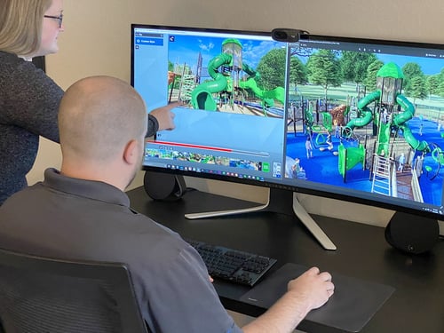man and woman sitting at a computer designing a playground