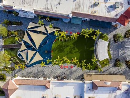 beautiful aerial shot of a park with blue covers on the side trees on the side