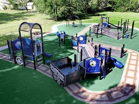 aerial shot of a blue park with green astro turf underneath