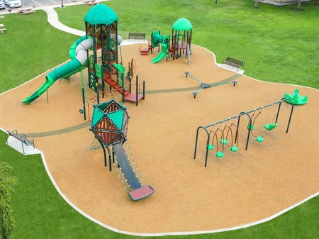 aerial shot of a lime green colored park with tan sand underneath