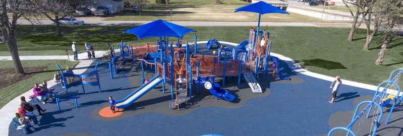 aerial shot of blue colored park with children playing on it