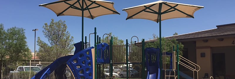 image of a blue themed park with tan overhead structures