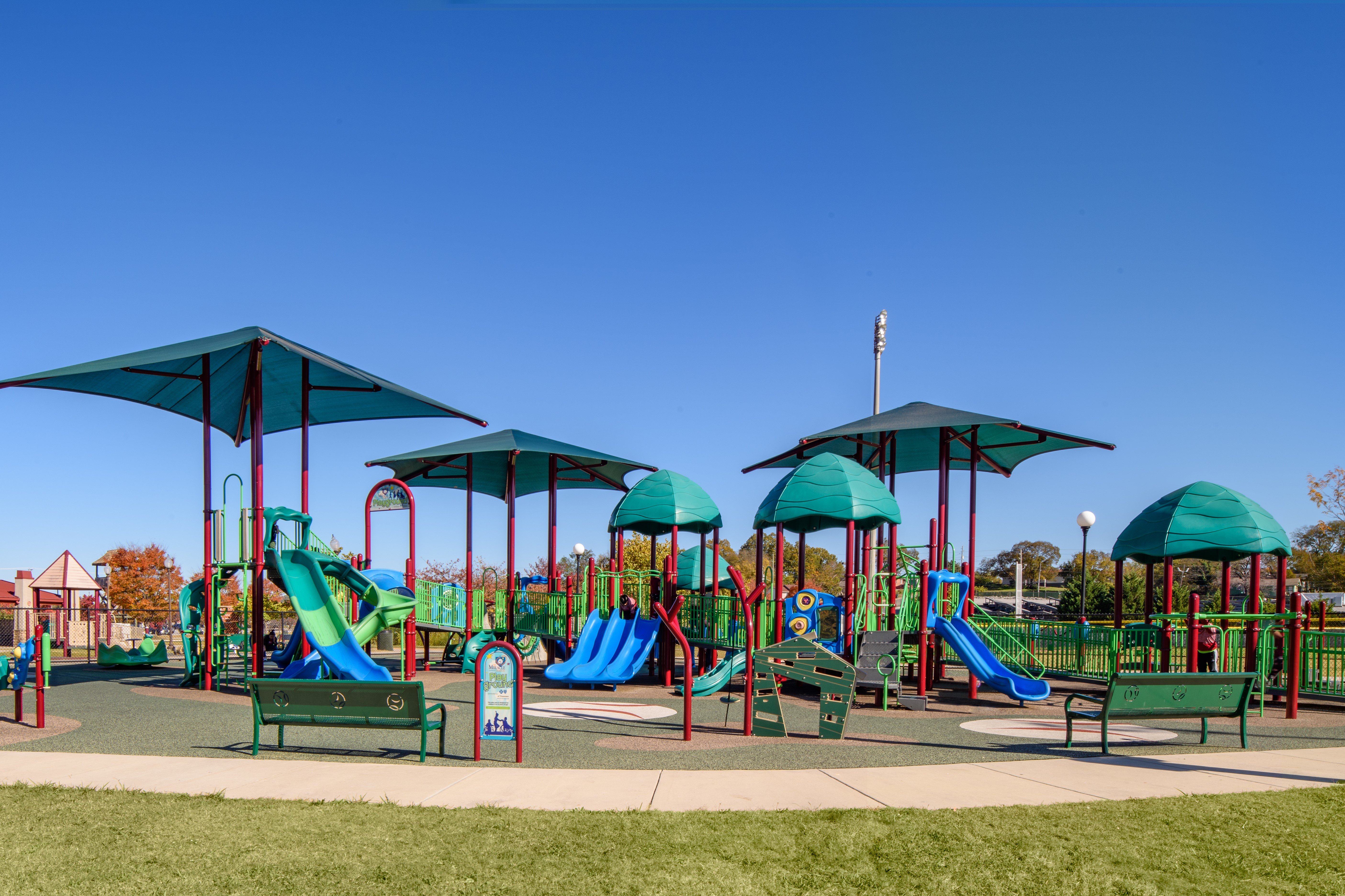 commercial playground equipment at a park on a sunny day
