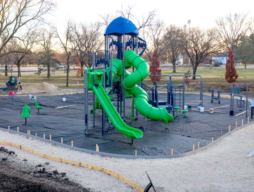 park with large green slides and a blue top
