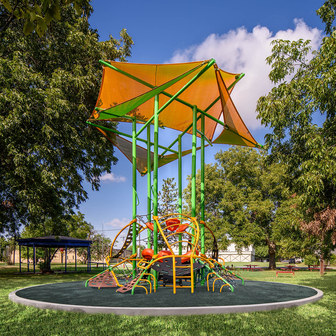 image of green and orange playground equipment with an orange overhead cover