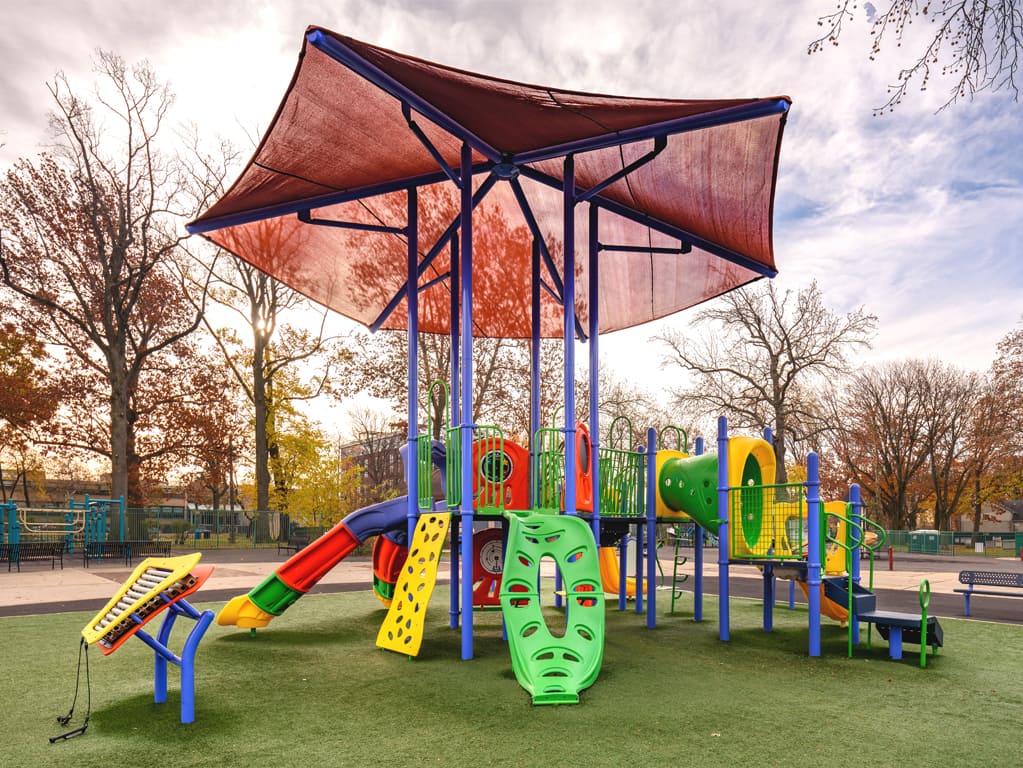 Colorful playground during the fall with a red cover 