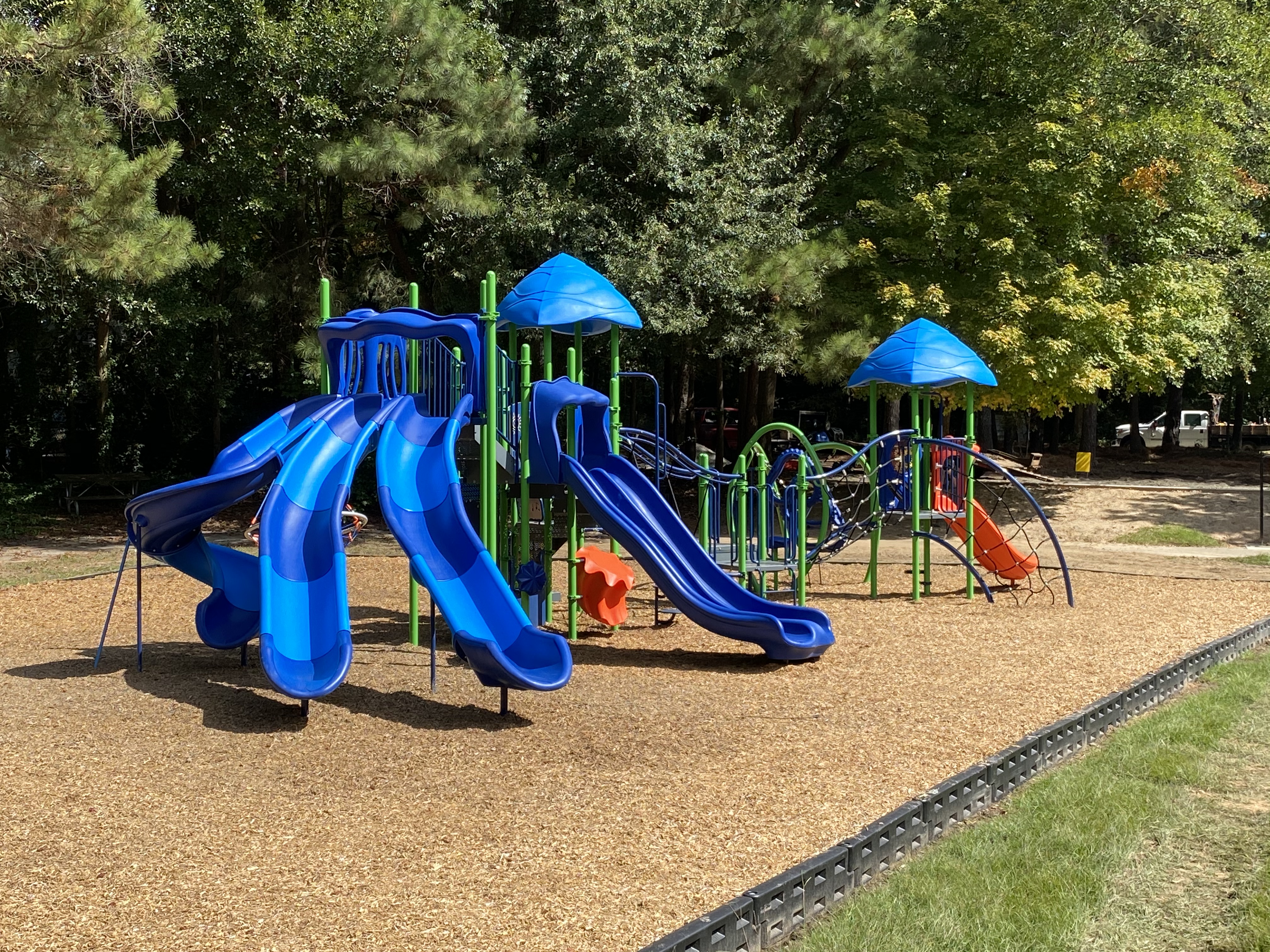 Blue, green, and orange playground during a sunny day