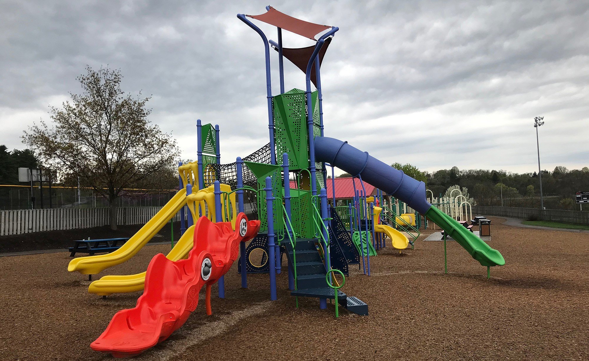 colorful playground park with three slides during cloudy day