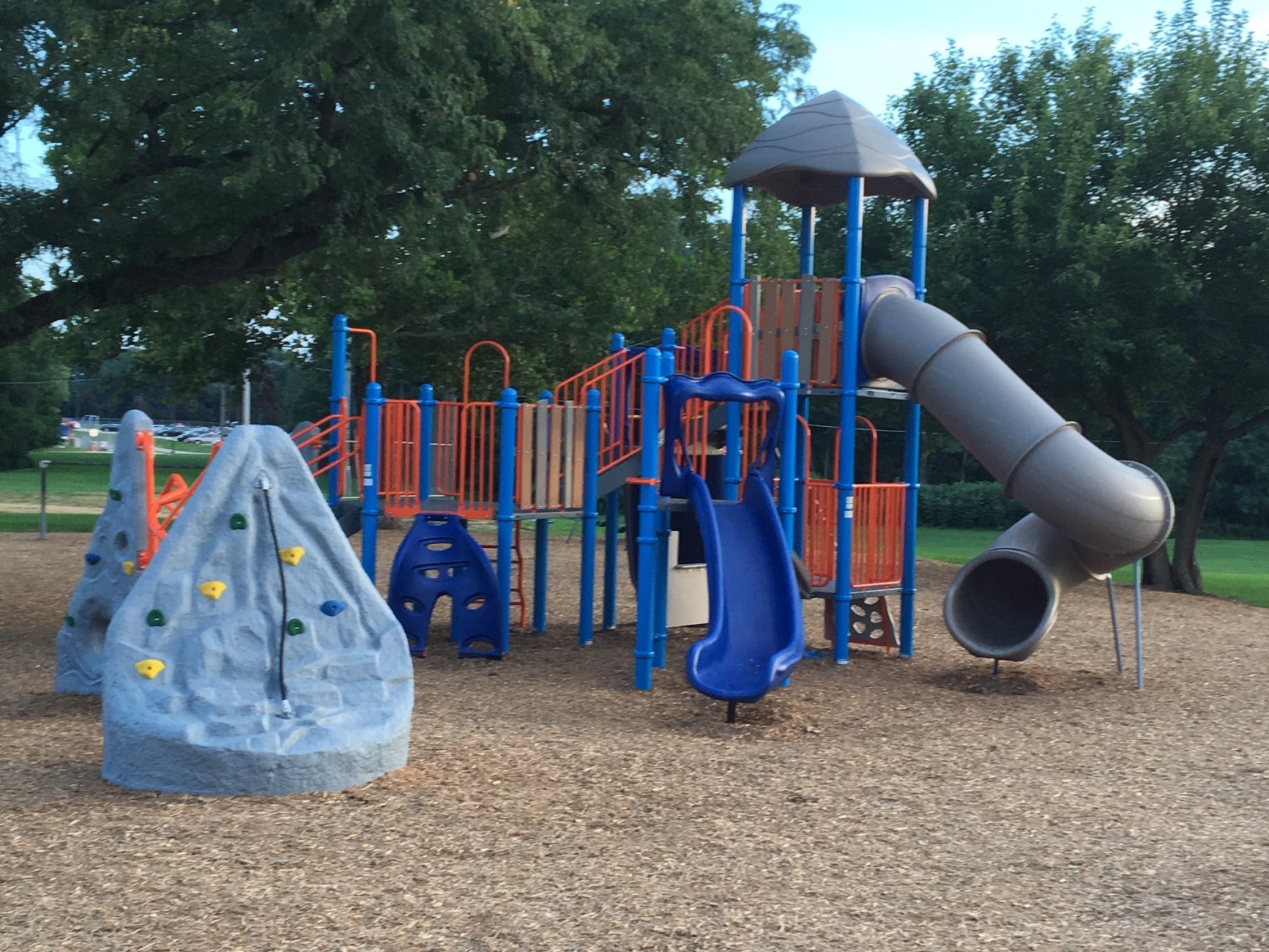 image of a blue park with light blue rocks with no children playing on it