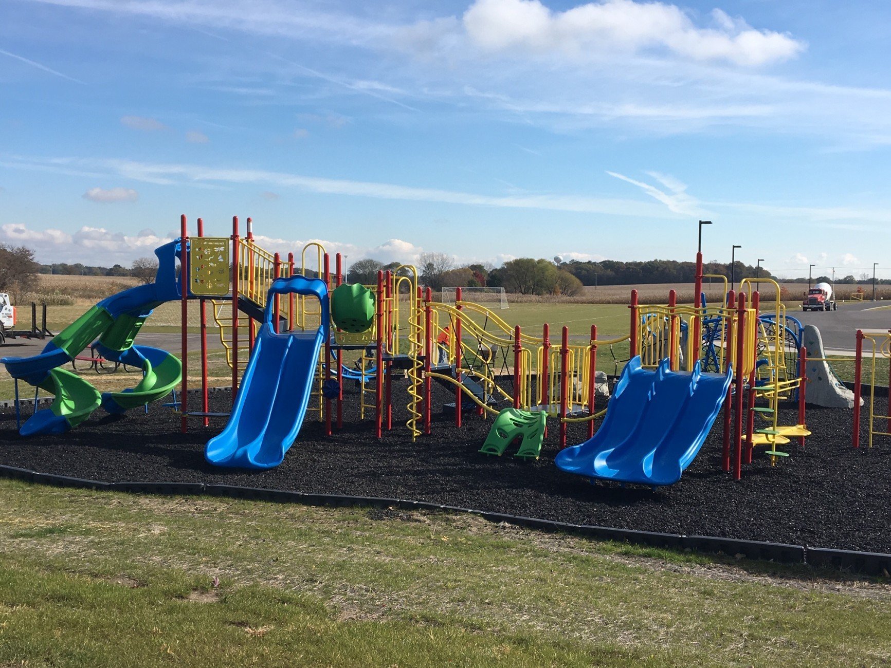 blue red and yellow colored playground park with several blue slides