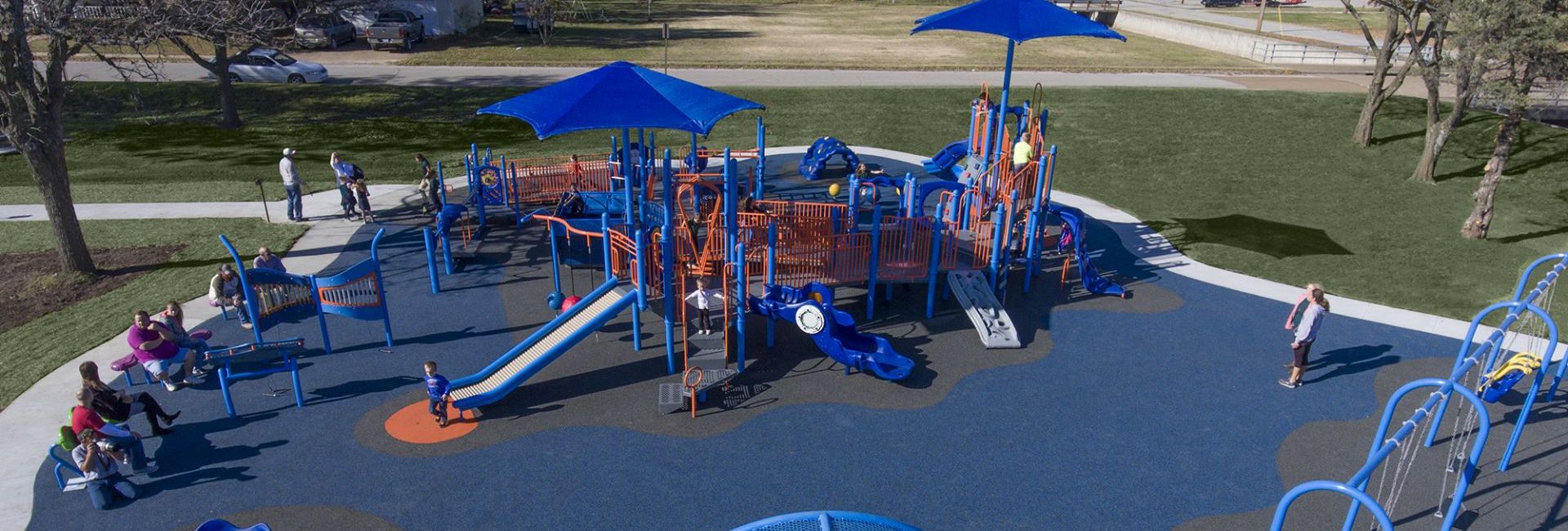 Aerial view of blue colored park with orange accent on blue and gray turf