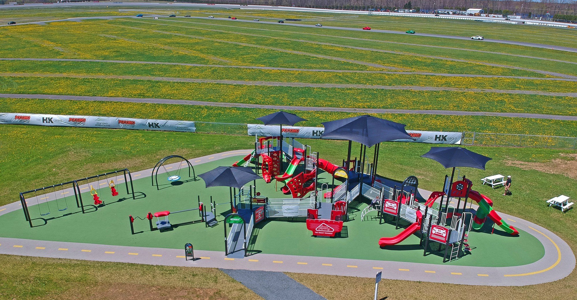 red themed Pocono Raceway Playground on green turf