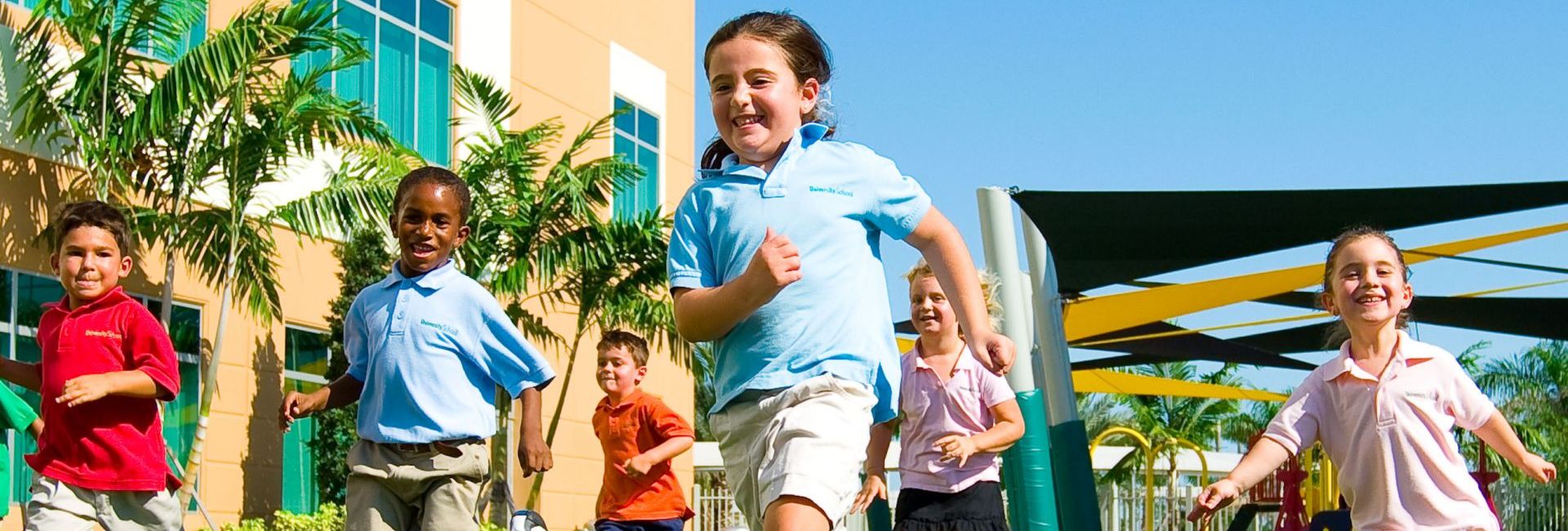 Group of children smiling running at playground