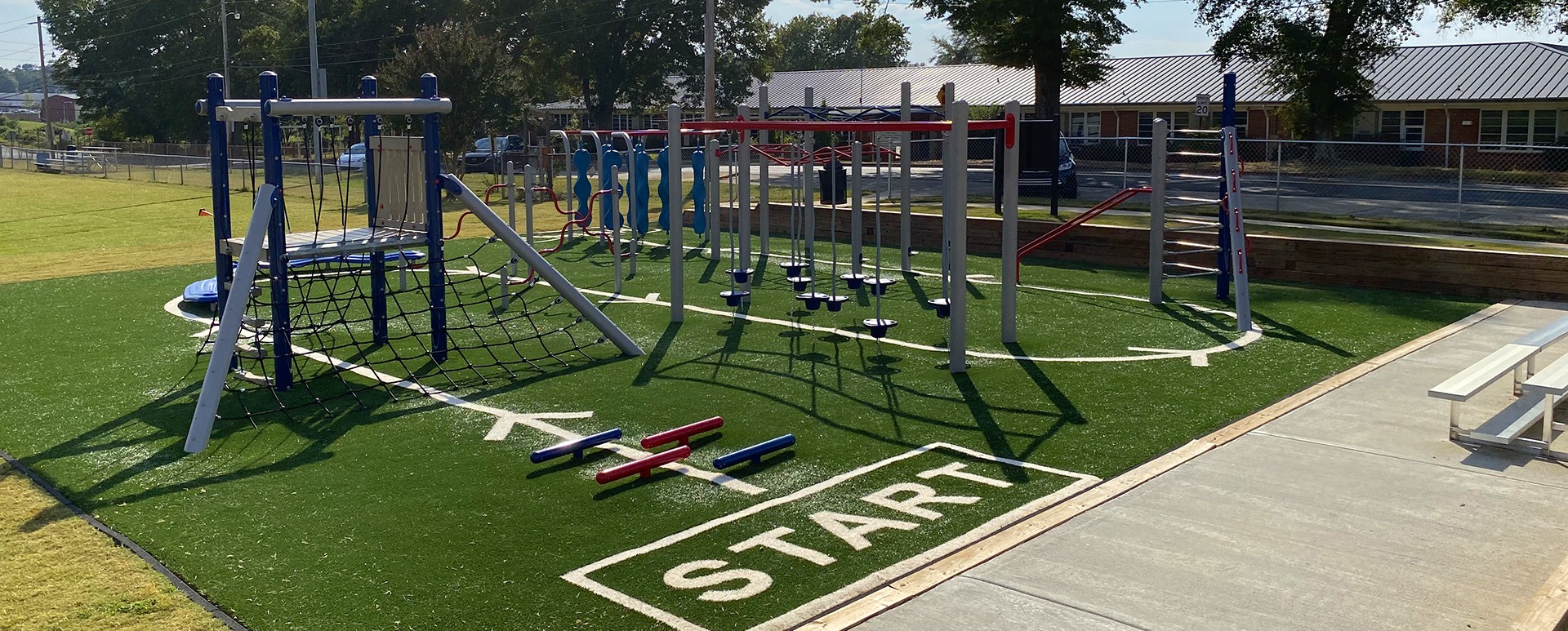 soccer net on green turn next to outdoor play equipment