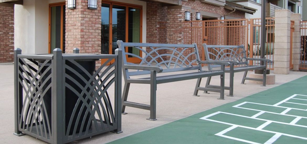 gray benches with nice designs in front of green turf with hopscotch lines