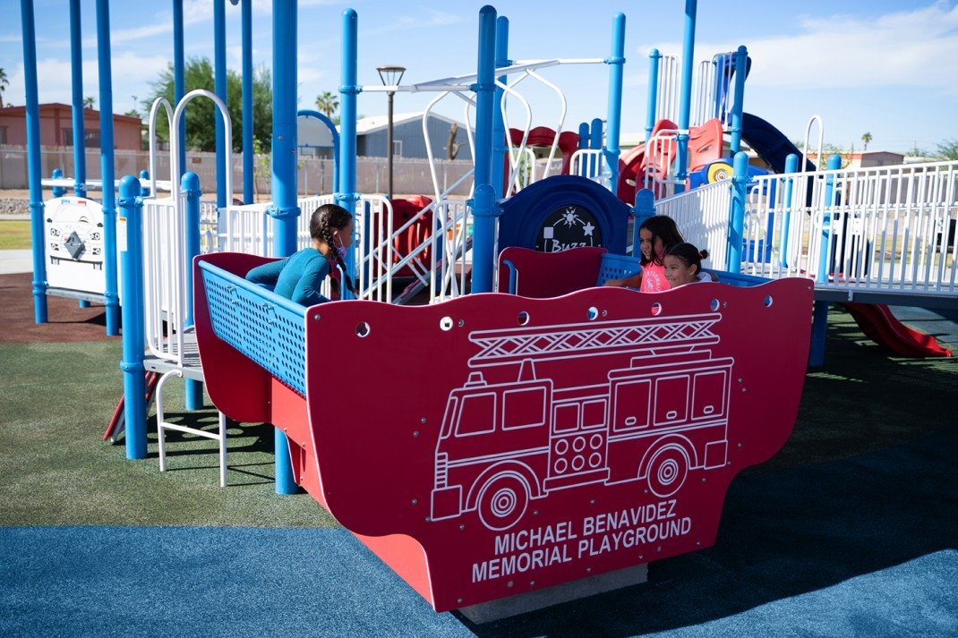 Children playing in red car object at park 