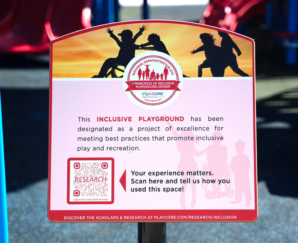 Inclusive playground sign with words at entrance of park