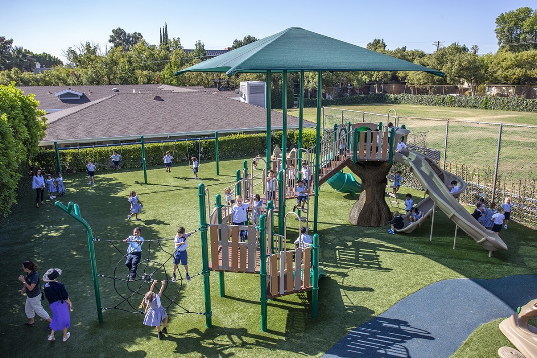 Mayfield School with green colored park and children playing on it