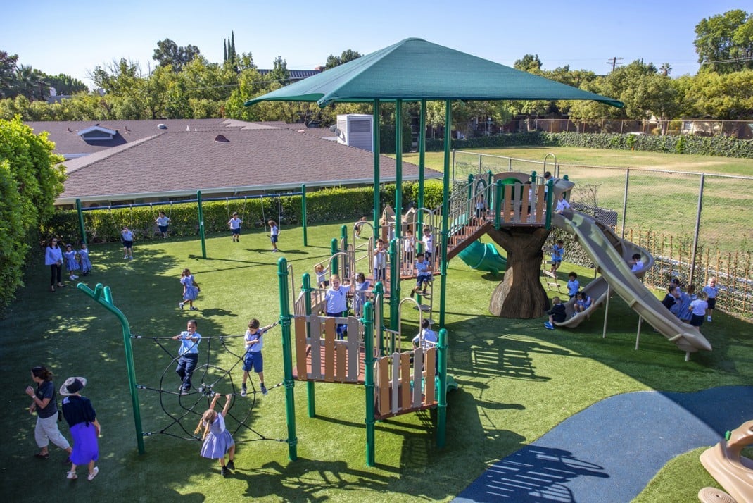 Mayfield School with green colored park and children playing on it